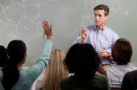 Chemistry Teacher with Students in Class --- Image by © Royalty-Free/Corbis